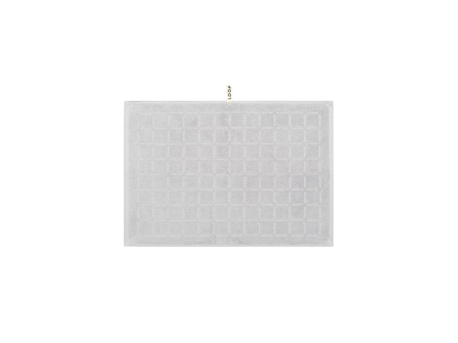 LOOP HOME stone hand towel neatly folded on plain background