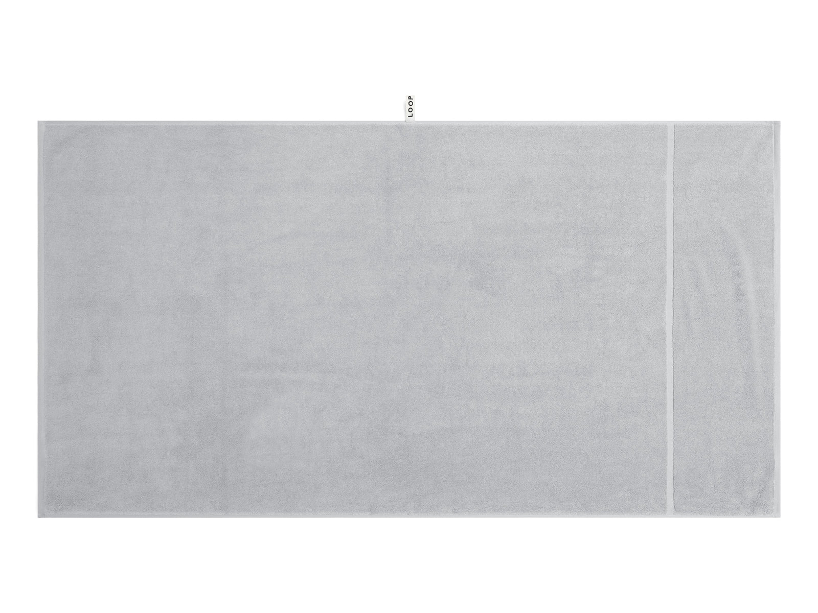 LOOP HOME stone bath sheet folded on plain background