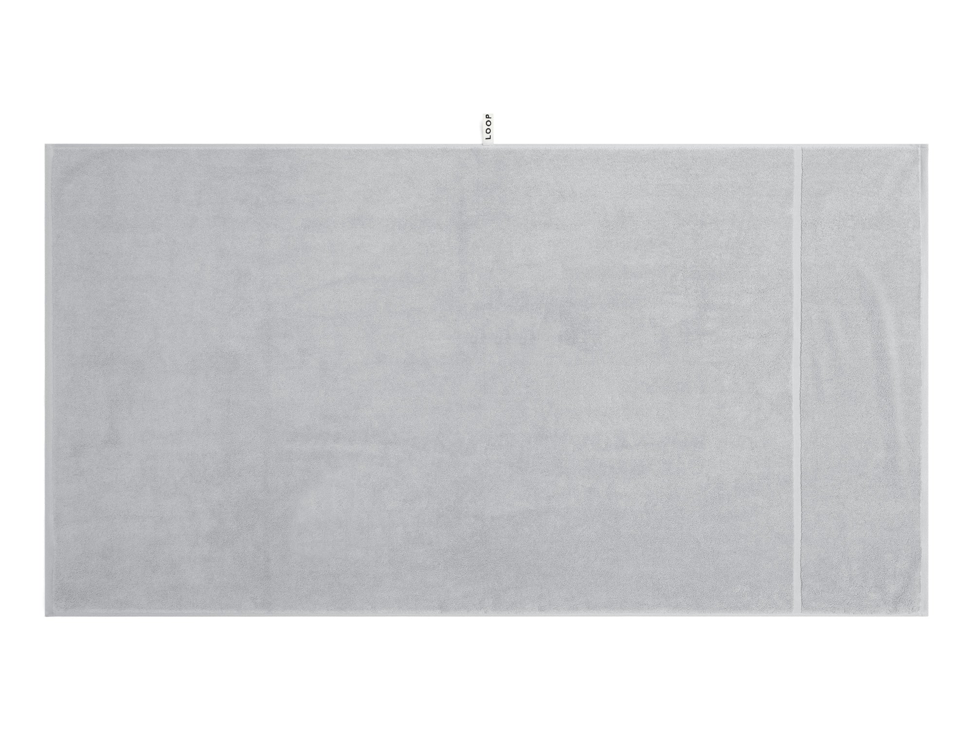 LOOP HOME stone bath sheet folded on plain background