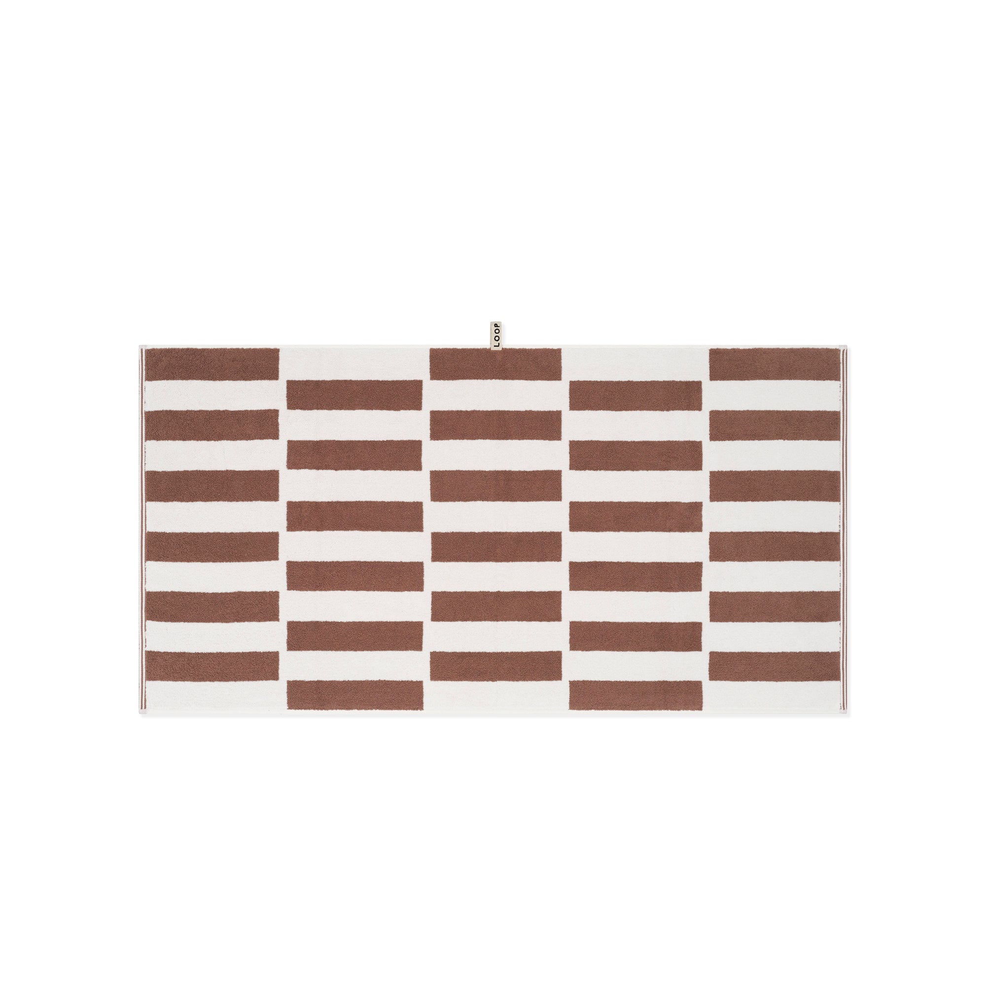 LOOP HOME cobalt and ivory bath towel folded on plain background