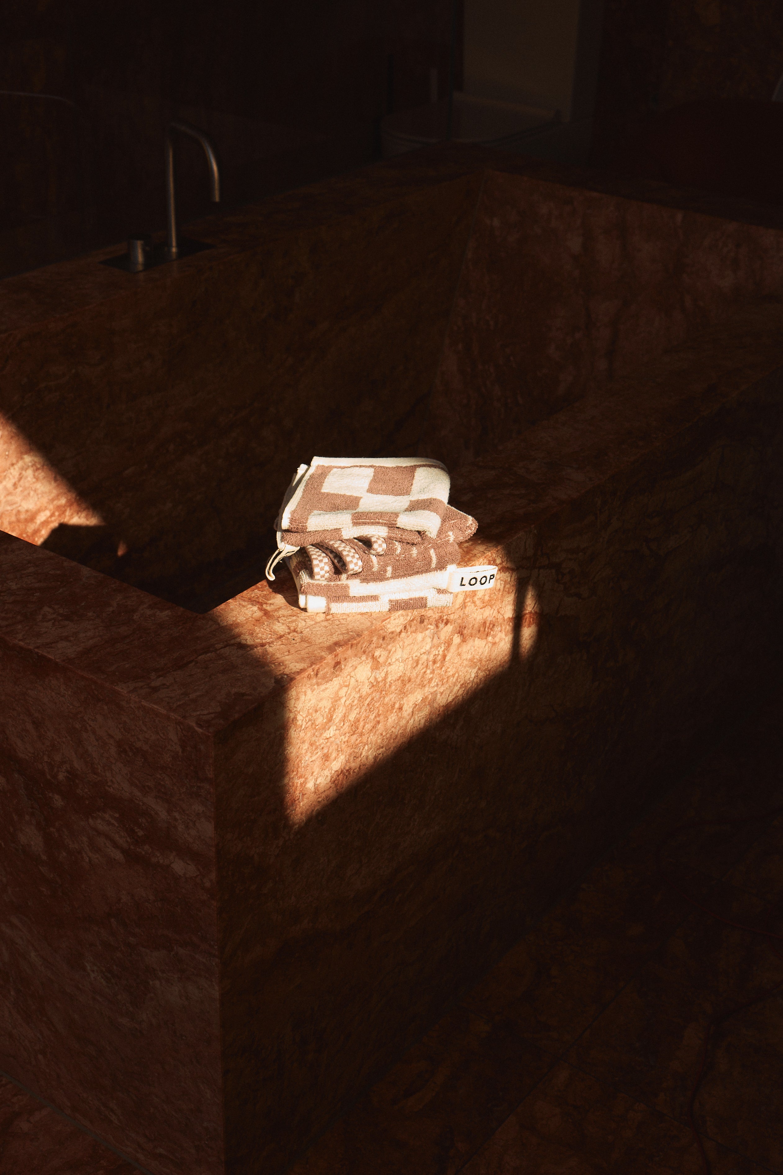 LOOP HOME organic cotton bedding collection displayed on a bed